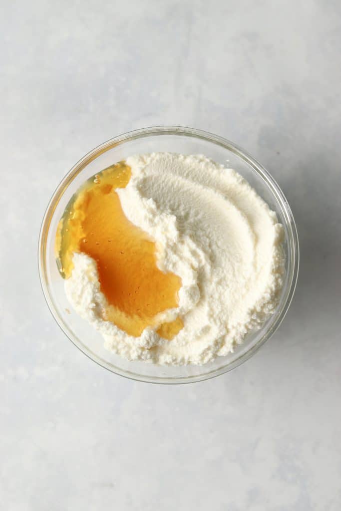 Ricotta and honey in a bowl