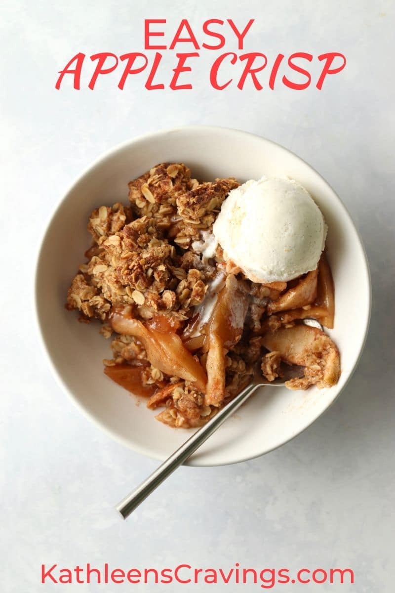 apple crisp with oat topping with vanilla ice cream in bowl.