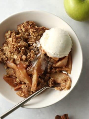 apple crisp with oat topping in a bowl