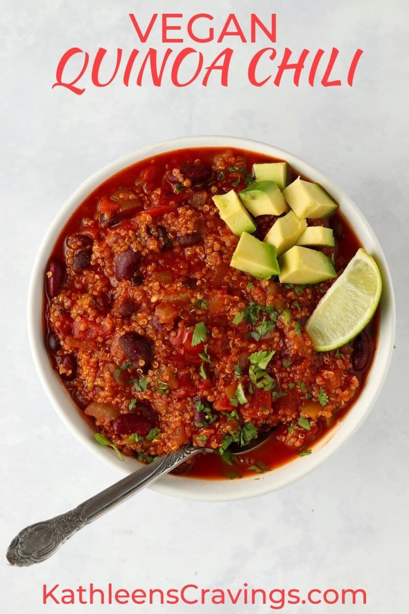 vegan quinoa chili in a bowl topped with avocado