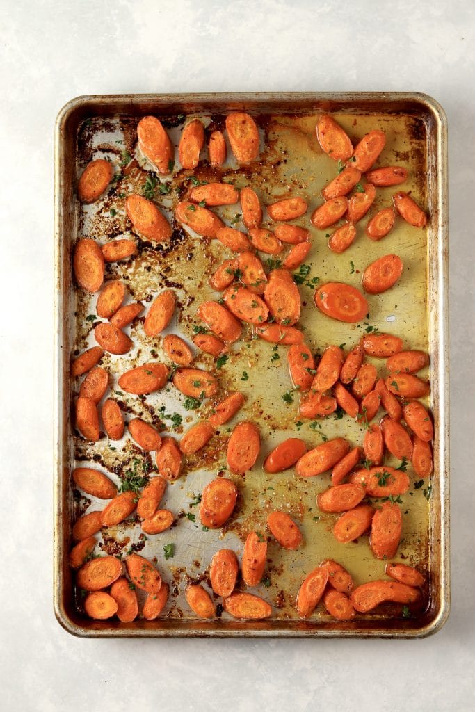 roasted carrots with honey glaze on baking sheet