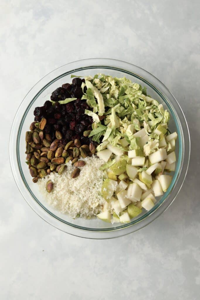 shredded brussels, dried cranberries, pistachios, parmesan cheese, and pears