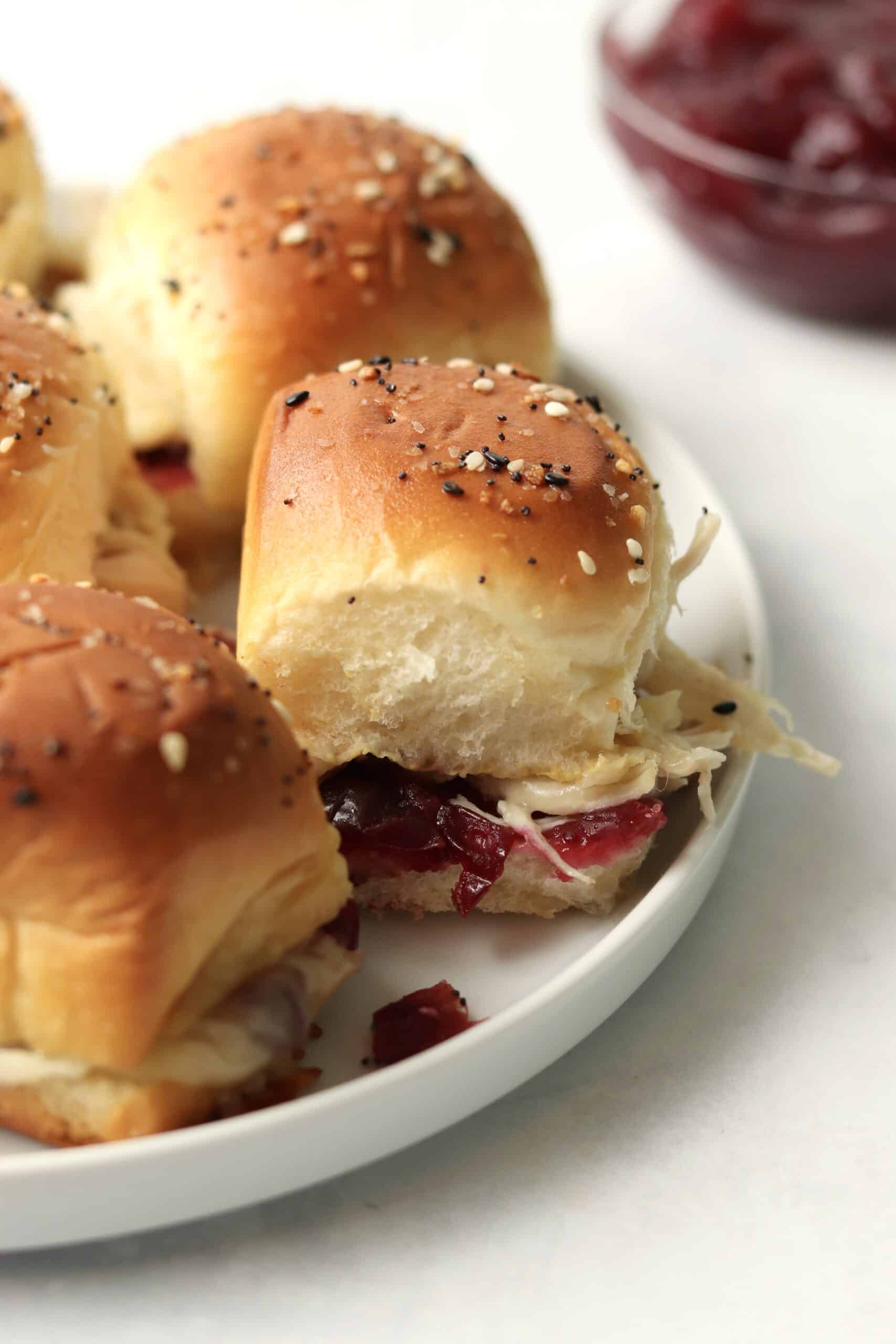 leftover thanksgiving turkey sliders on a plate with cranberry sauce