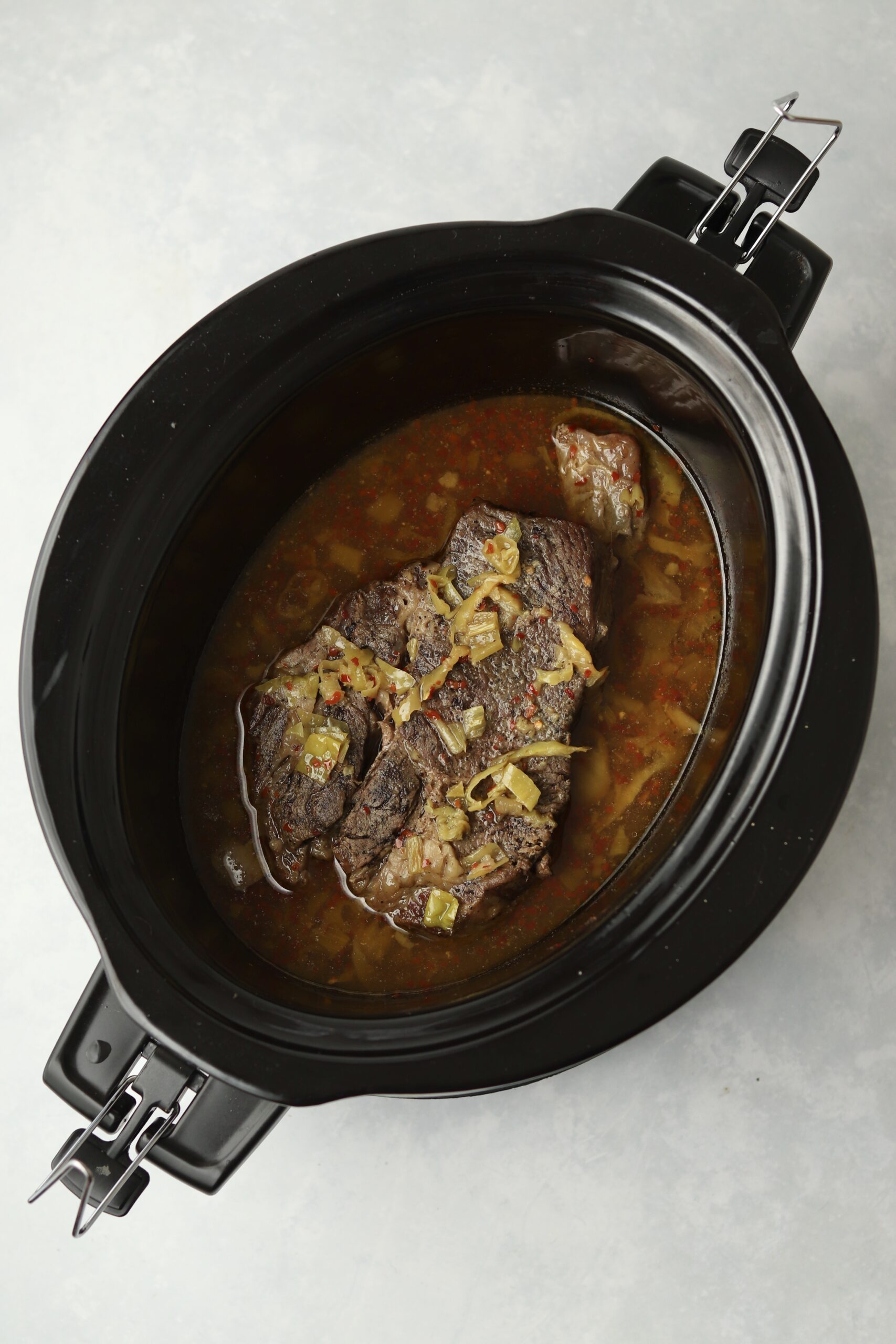 cooked chuck roast with peppers in slow cooker