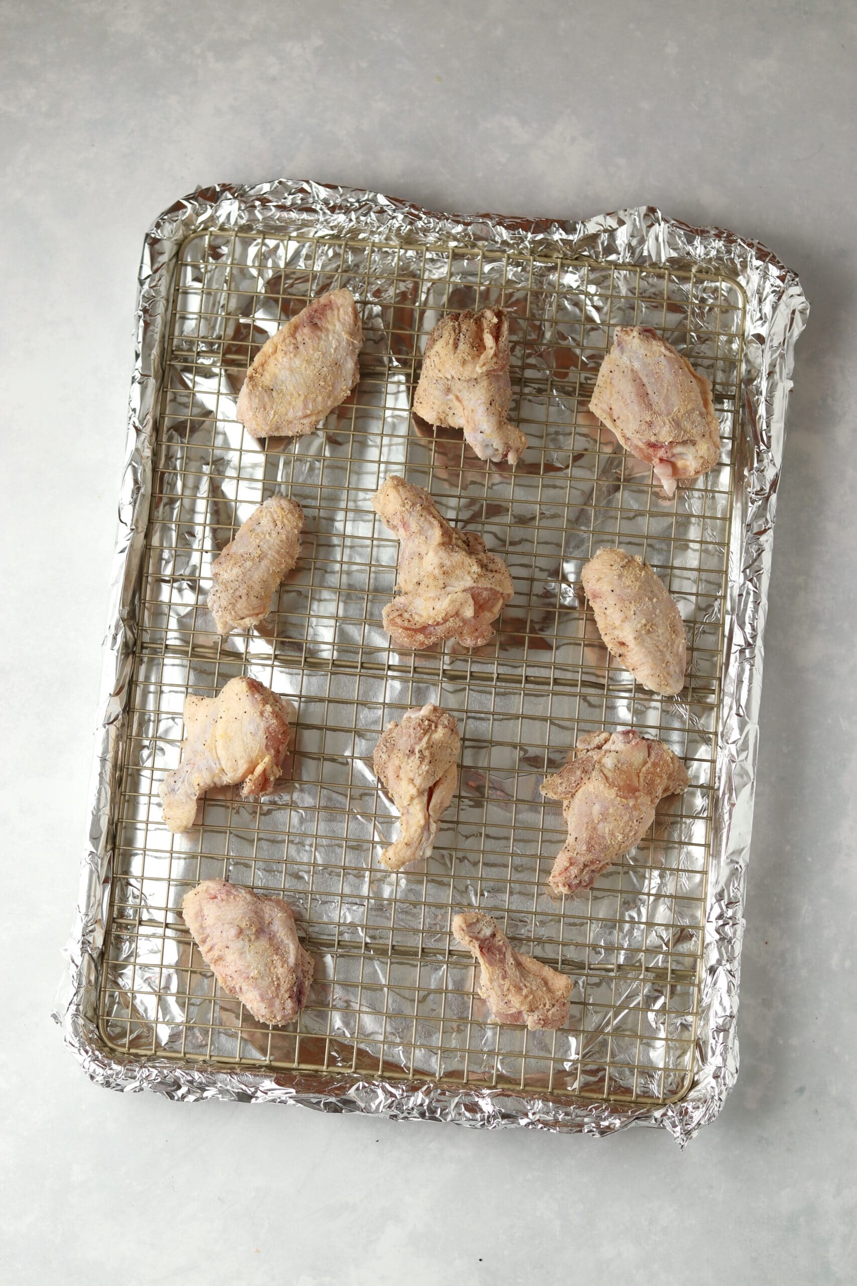 raw chicken wings on baking sheet