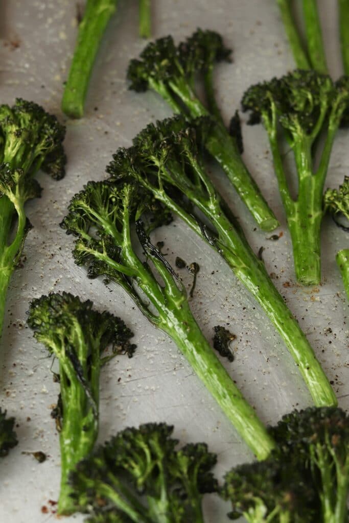 close up of roasted broccolini on a sheet pan