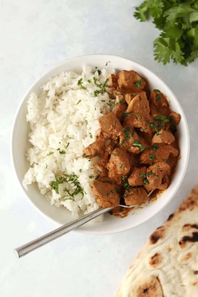 bowl of rice and Indian butter chicken