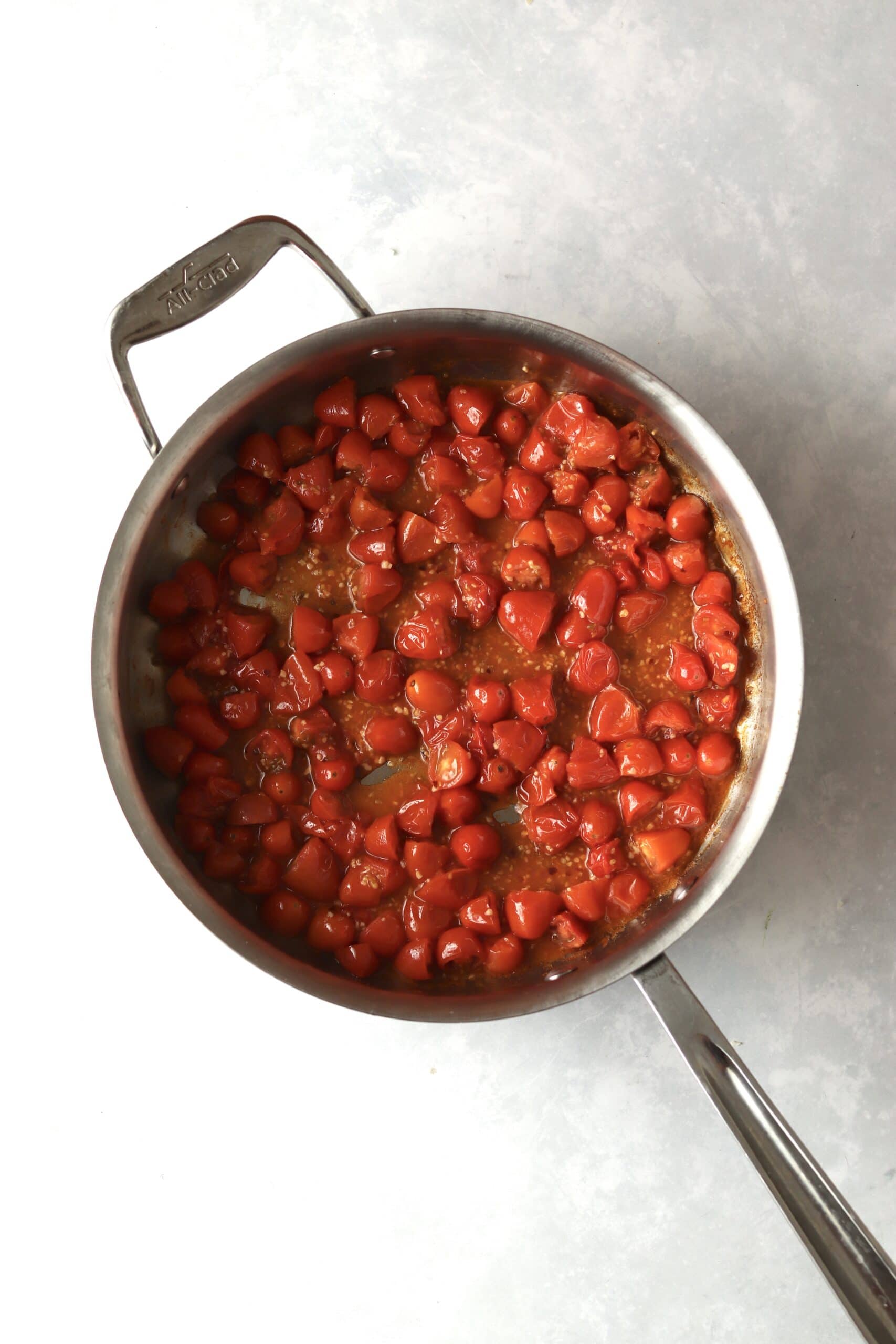 cooked grape tomatoes in pan