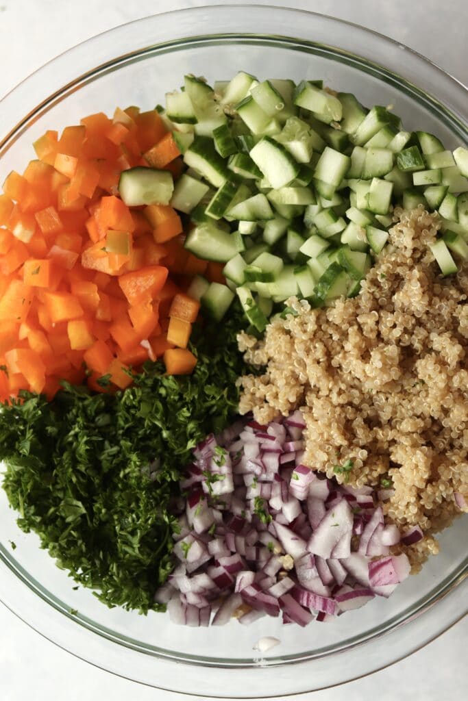 quinoa, veggies, and parsley in glass bowl