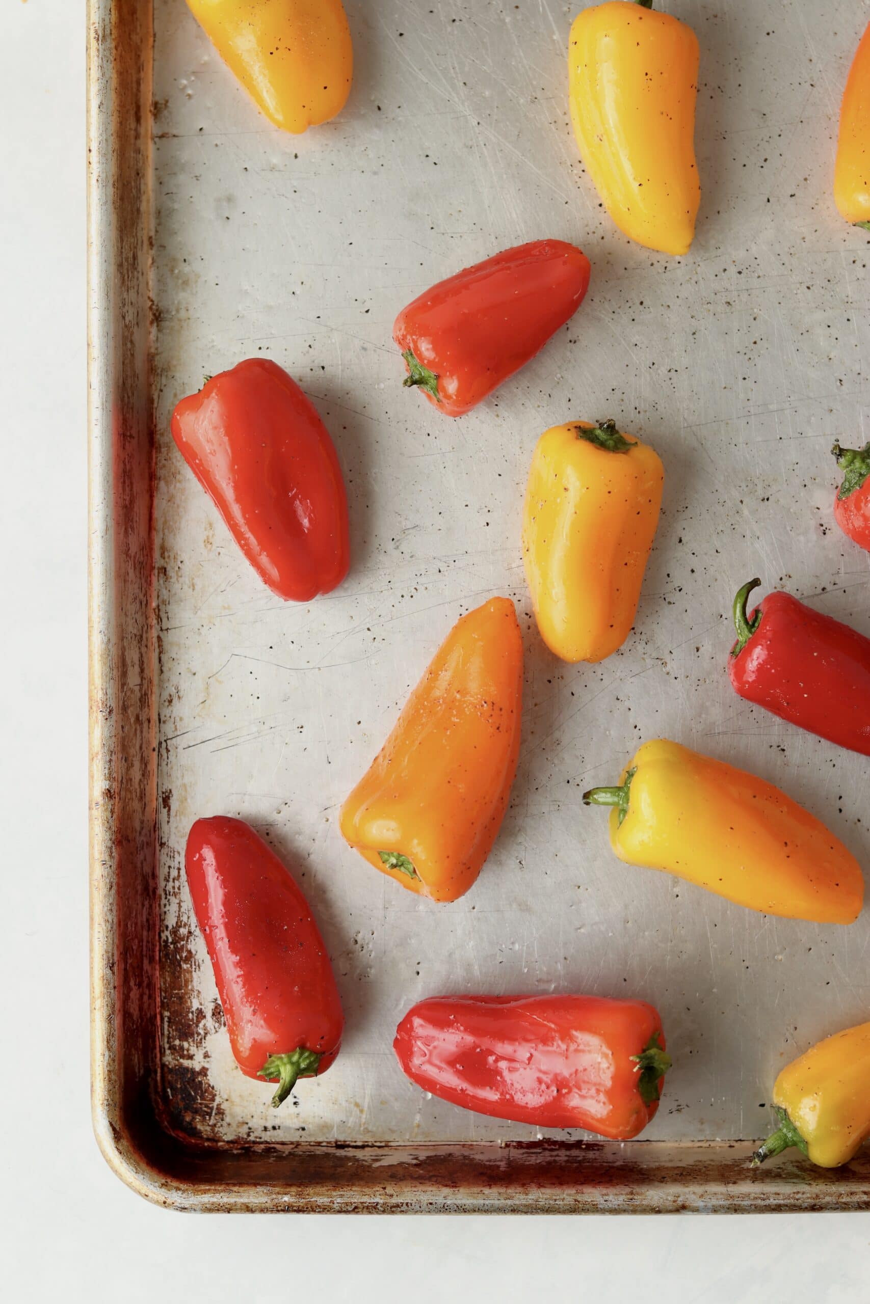 raw peppers on a sheet pan