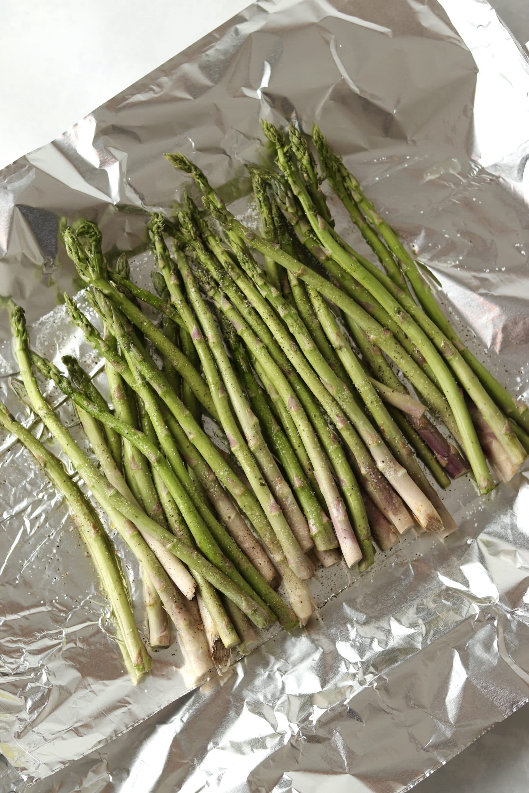 raw asparagus on foil