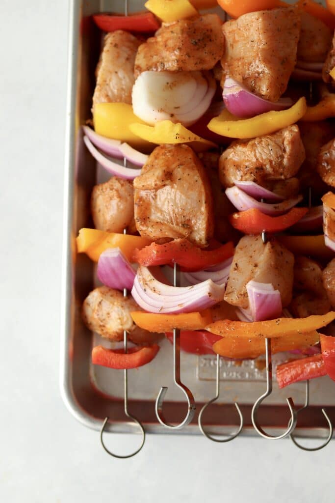 raw chicken with veggies on skewers