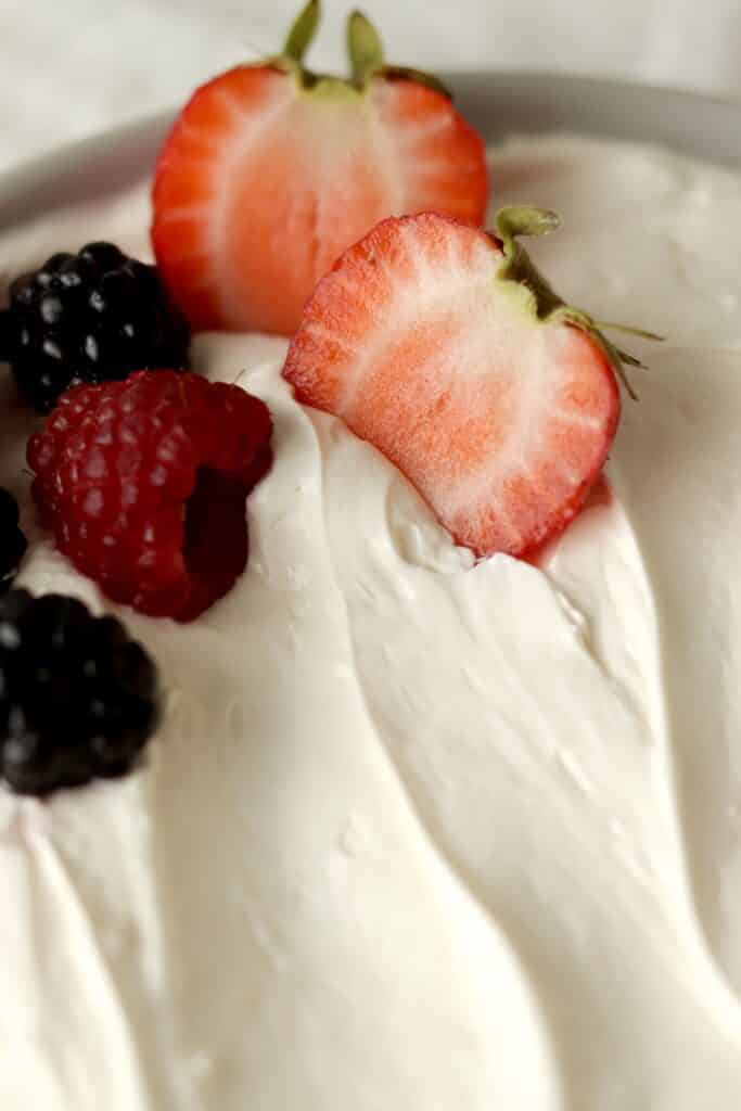 close up of creamy fruit dip with strawberries