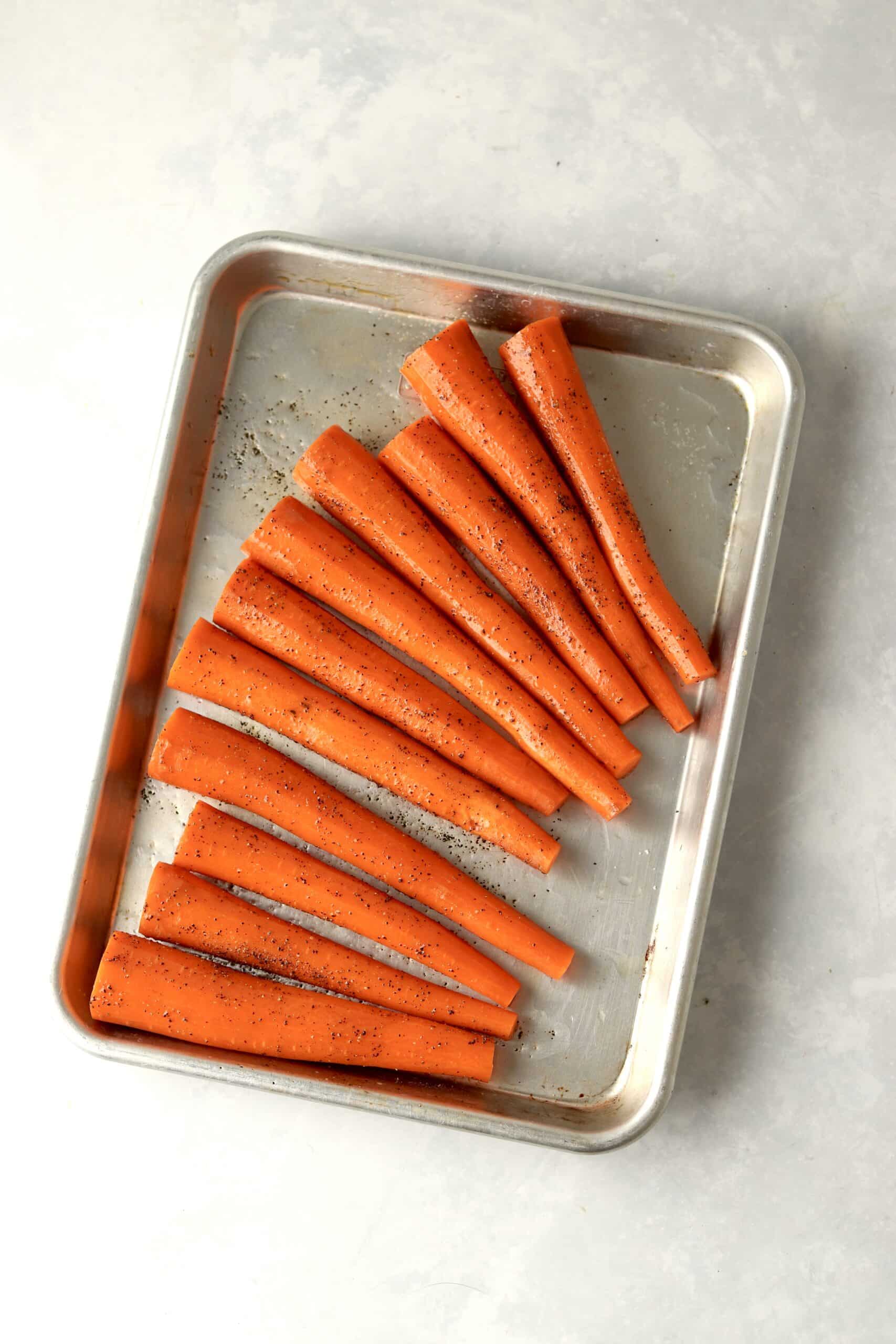 raw whole carrots on a sheet pan