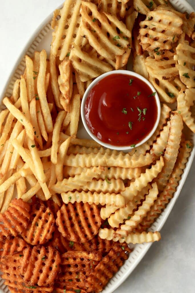 crispy fries on a platter with ketchup