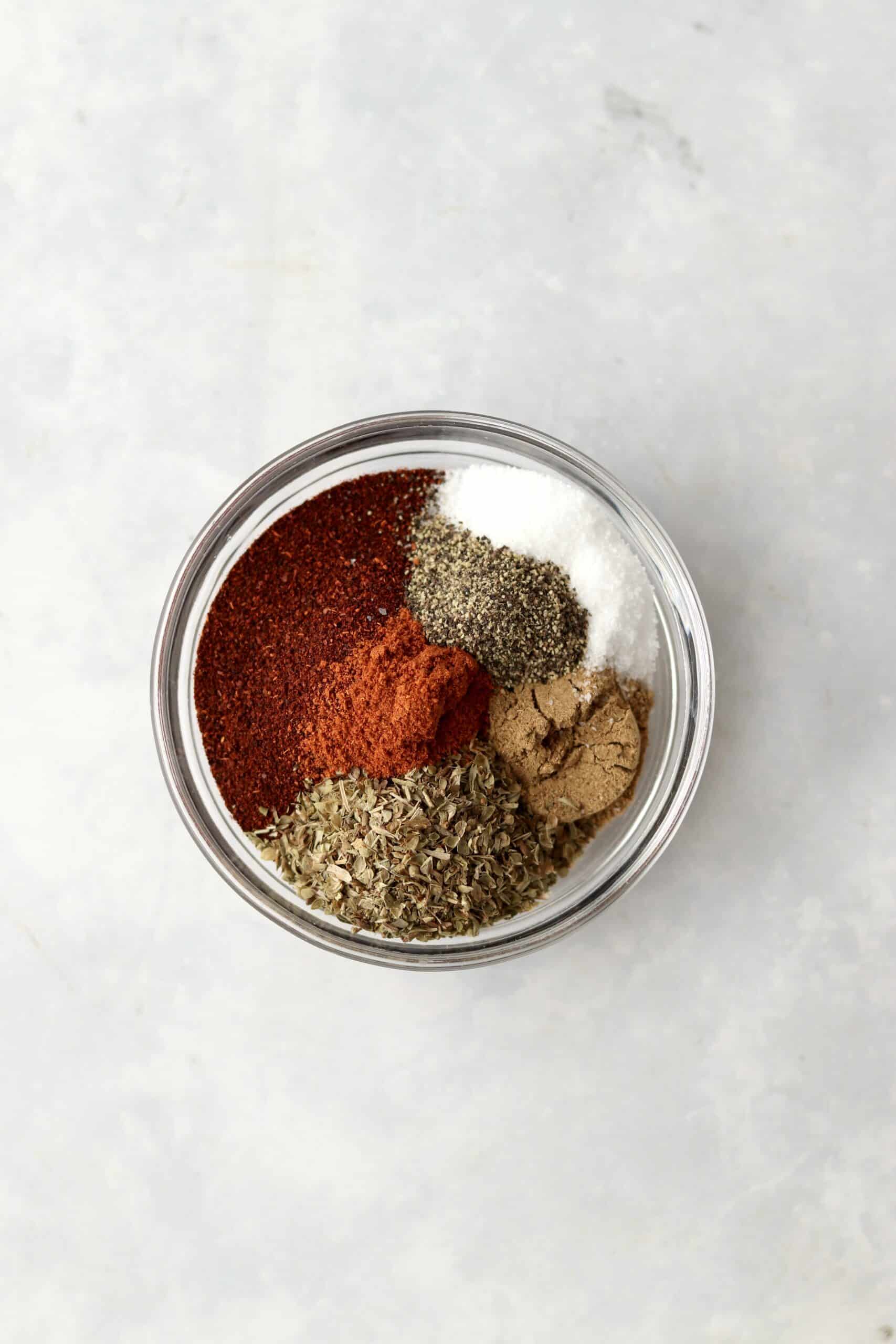 spices for chili in glass bowl