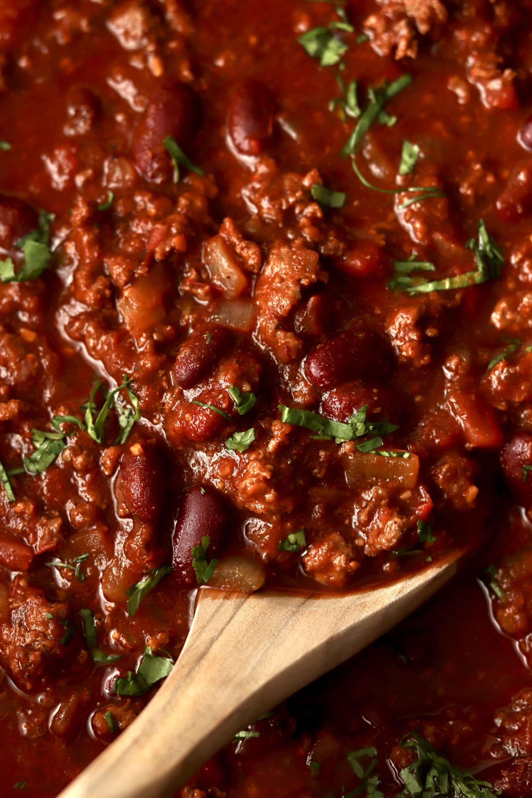 close up of classic chili with wooden spoon