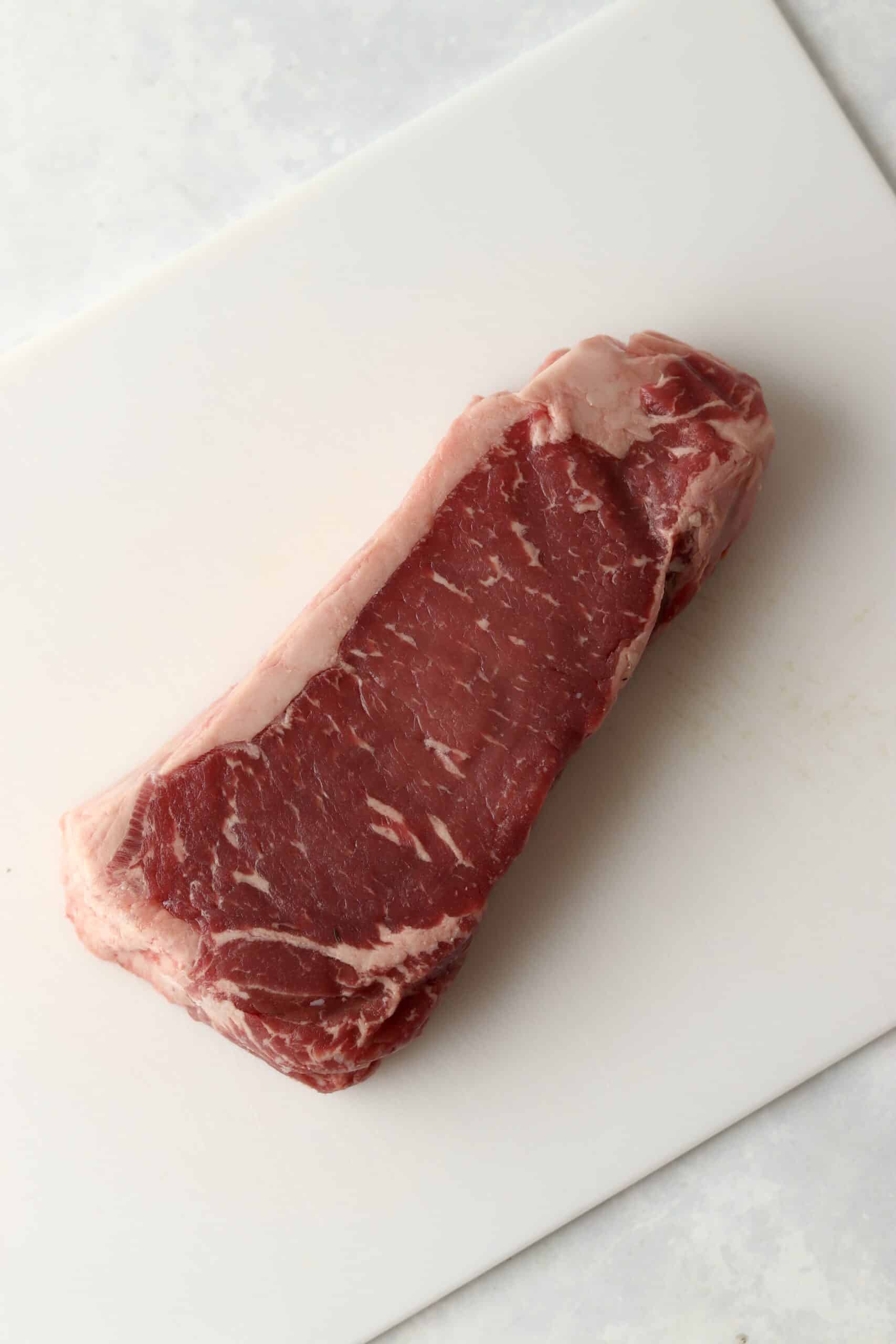 rib eye steak on cutting board