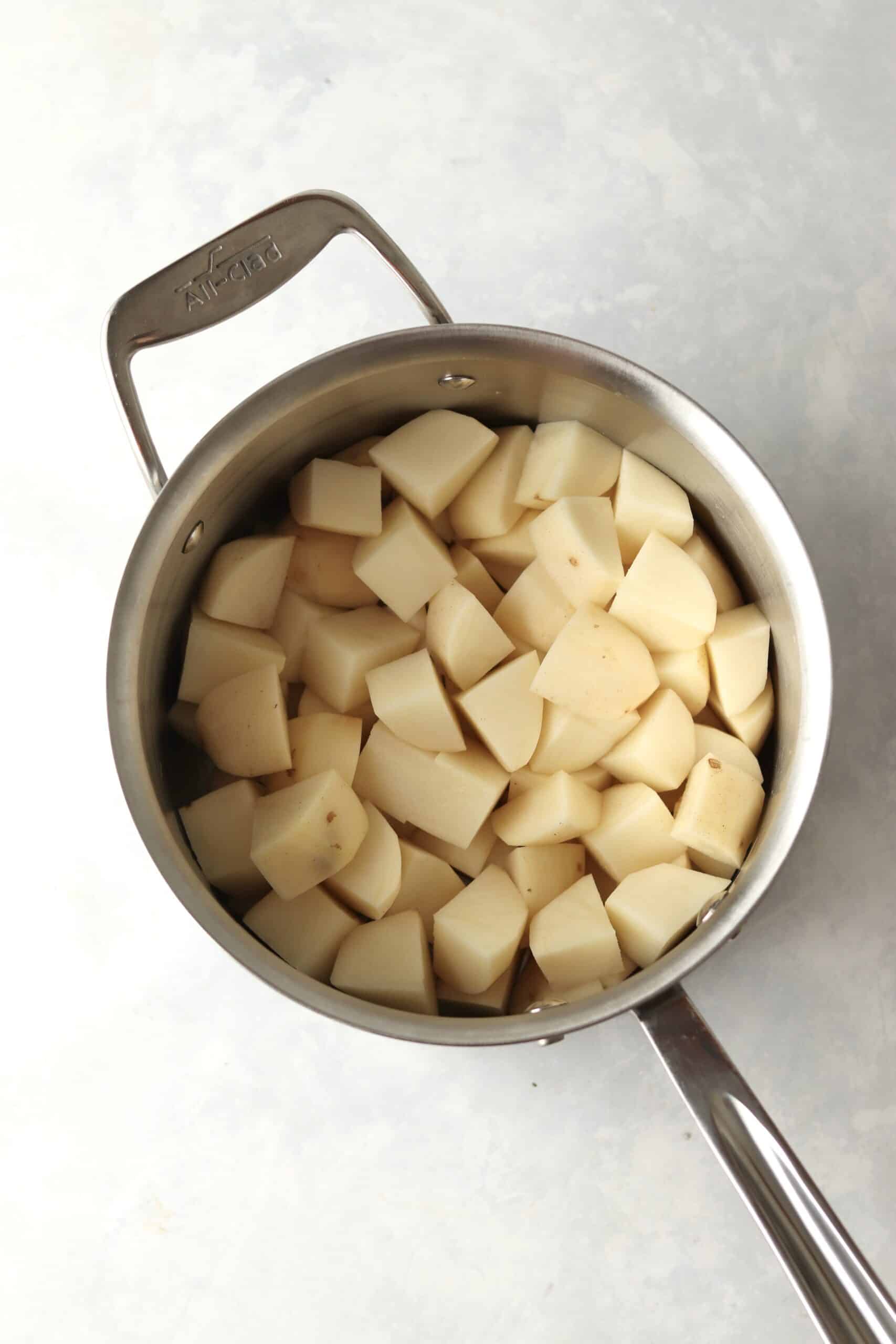raw russet potatoes in pot