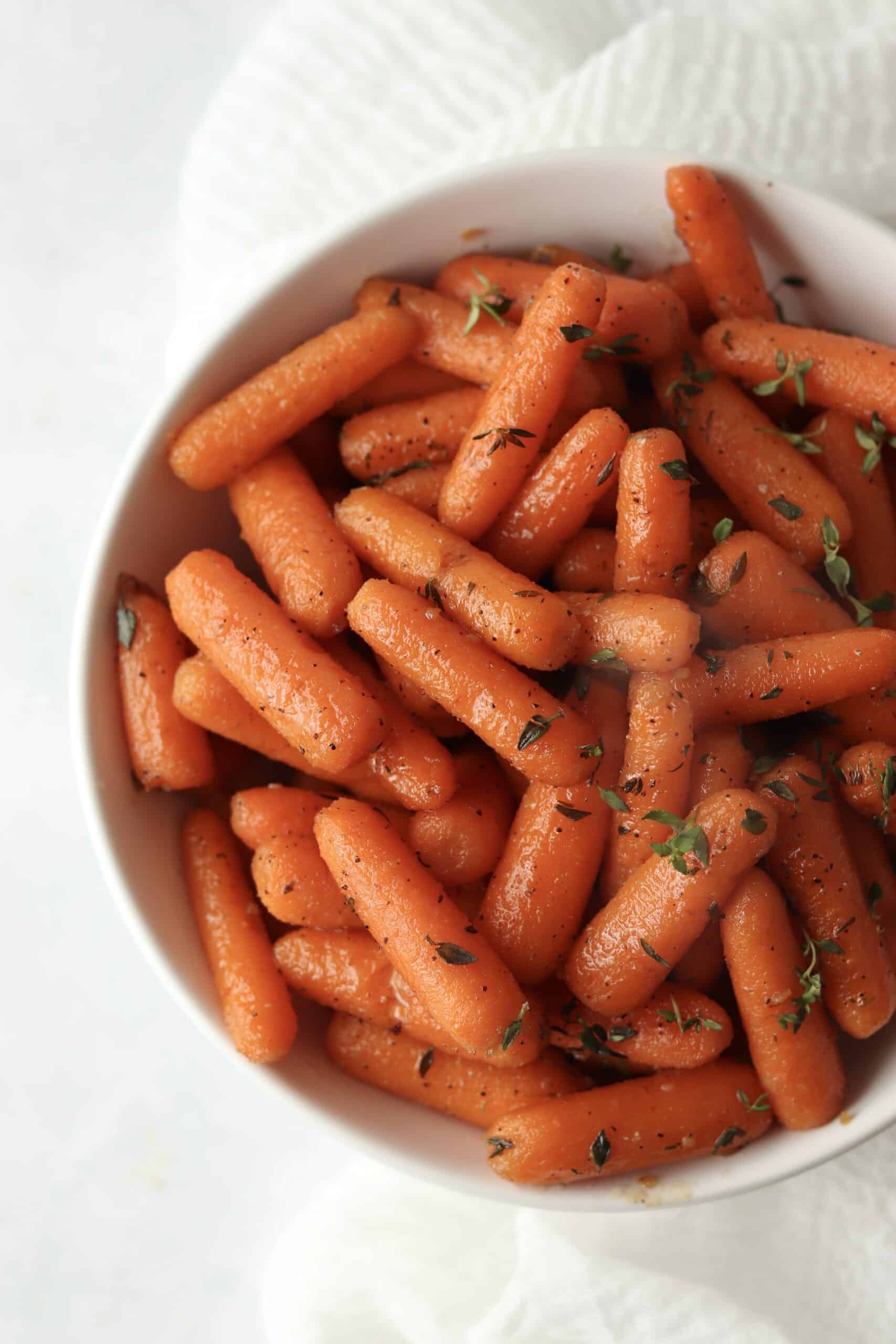 brown sugar glazed carrots with thyme in a bowl