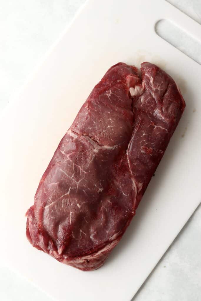 large sirloin steak on a cutting board