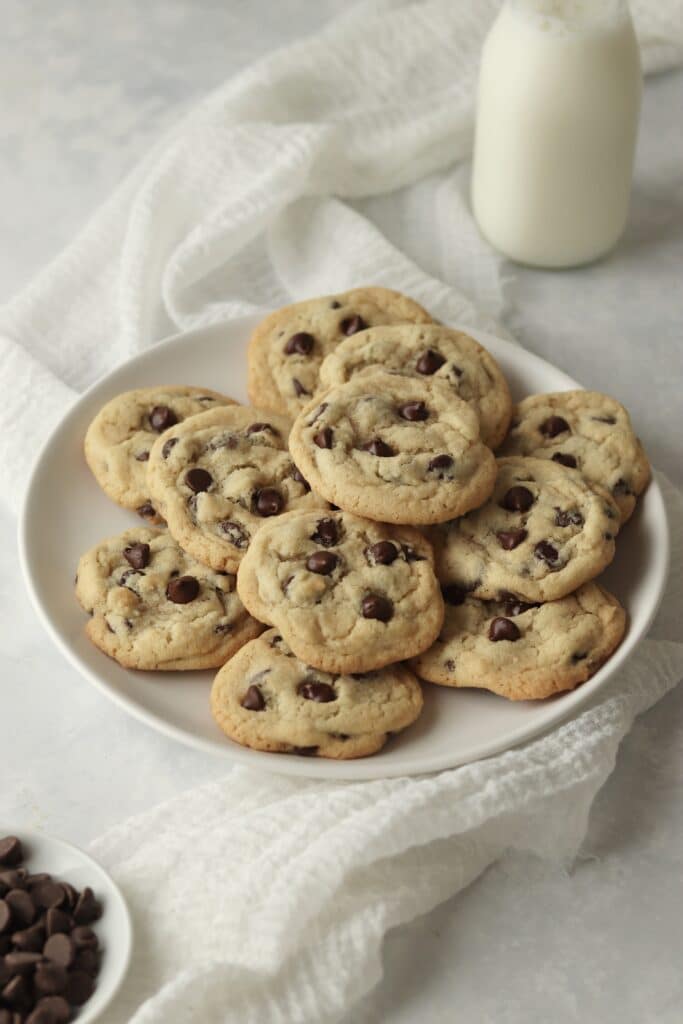 plate of cookies with chocolate chips and milk