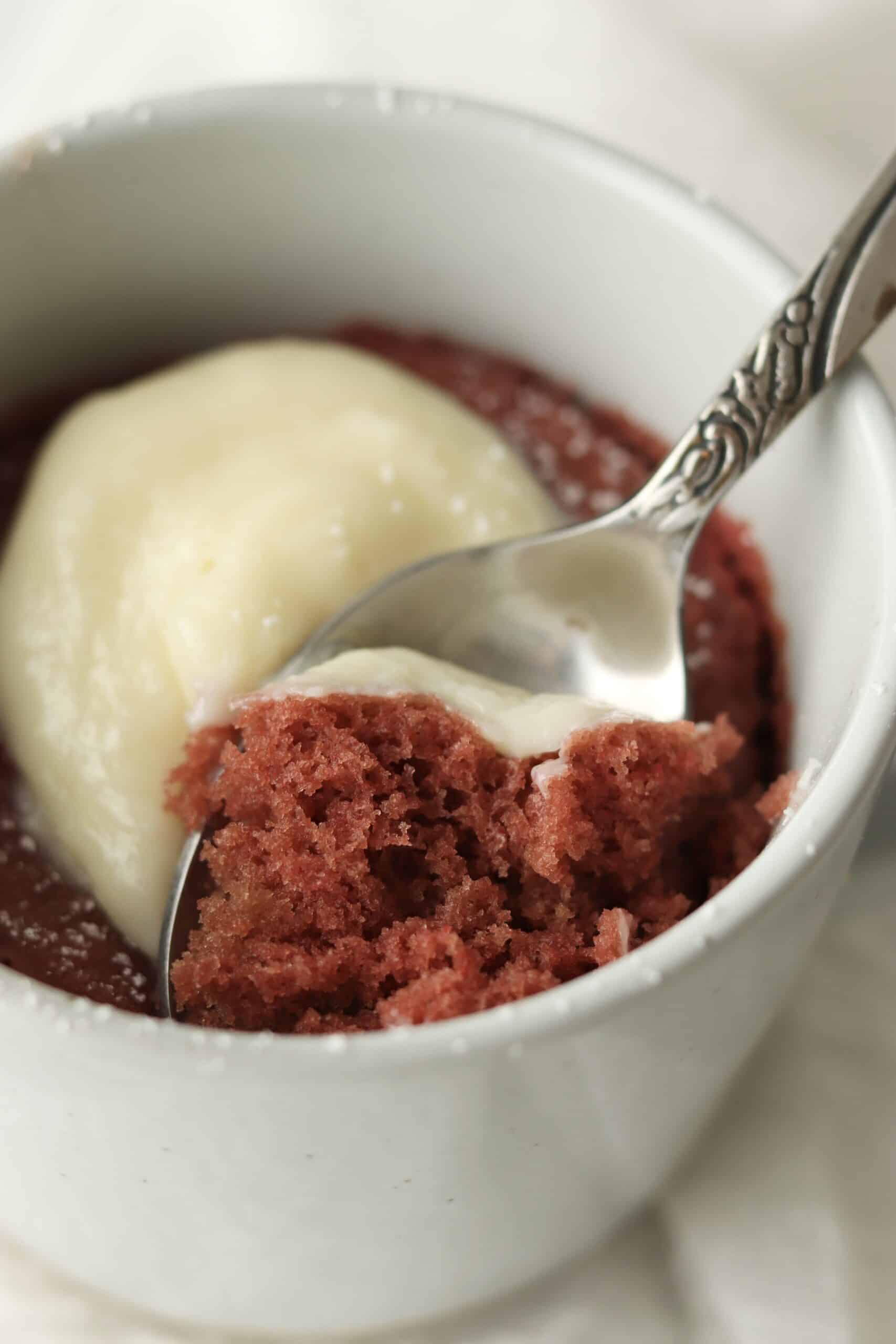 spoon dipping into red velvet mug cake