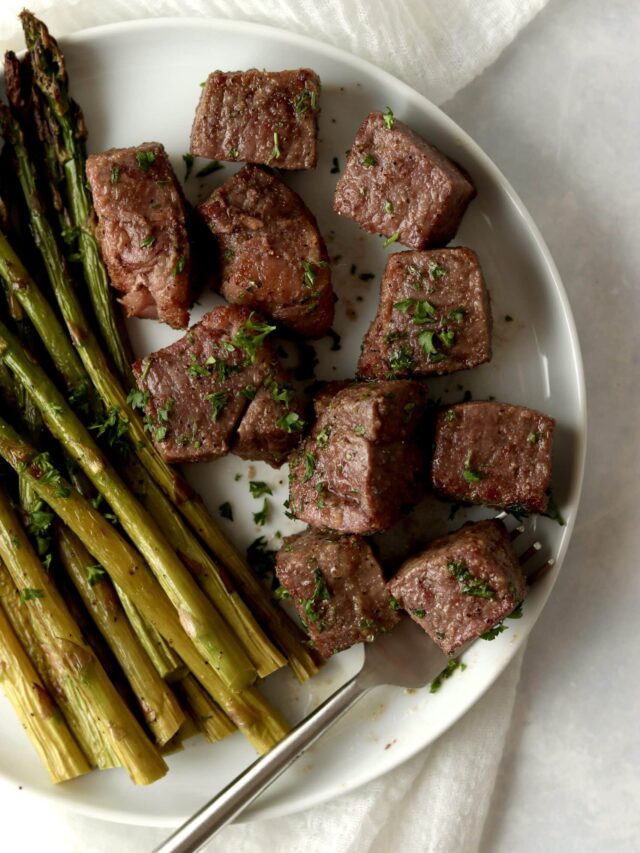 steak bites with asparagus on a plate