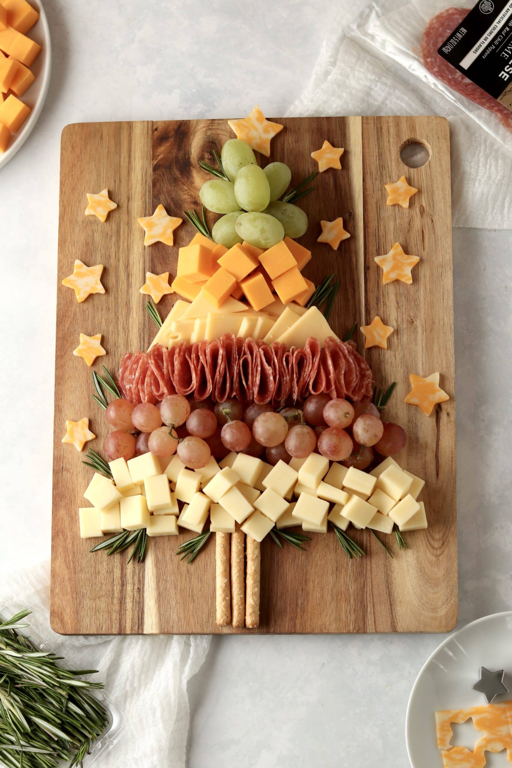 Christmas charcuterie board with salami and rosemary
