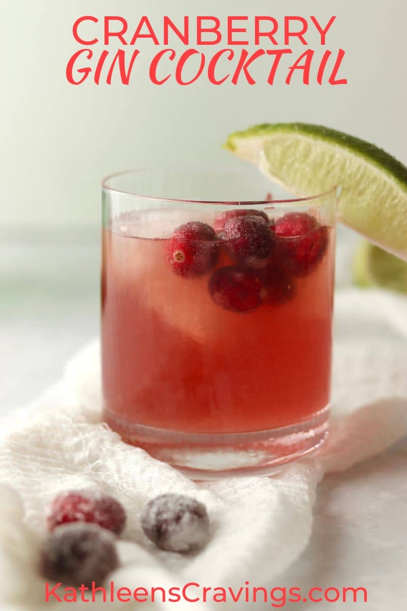 Cranberry Gin Cocktail with sugared cranberries and a lime wedge