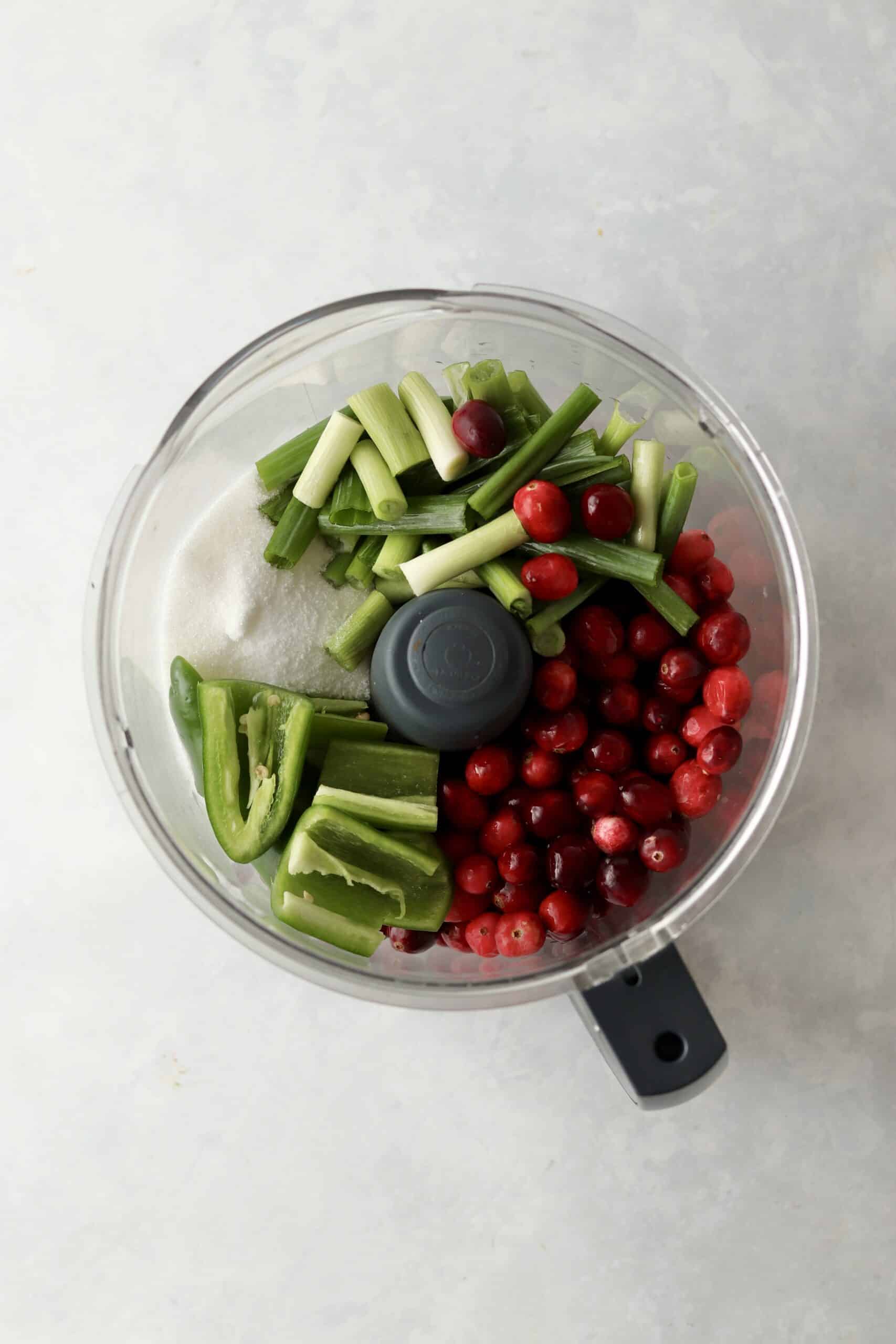 fresh cranberries, jalapeño, green onion, and sugar in a food processor.