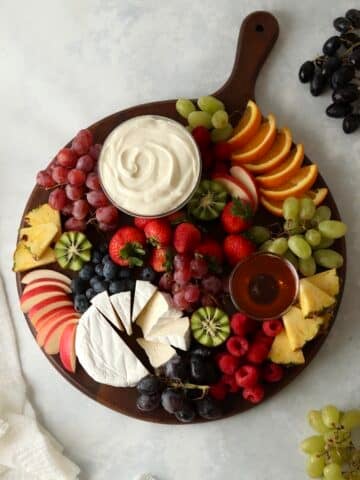 fruit charcuterie board with grapes on a wooden board