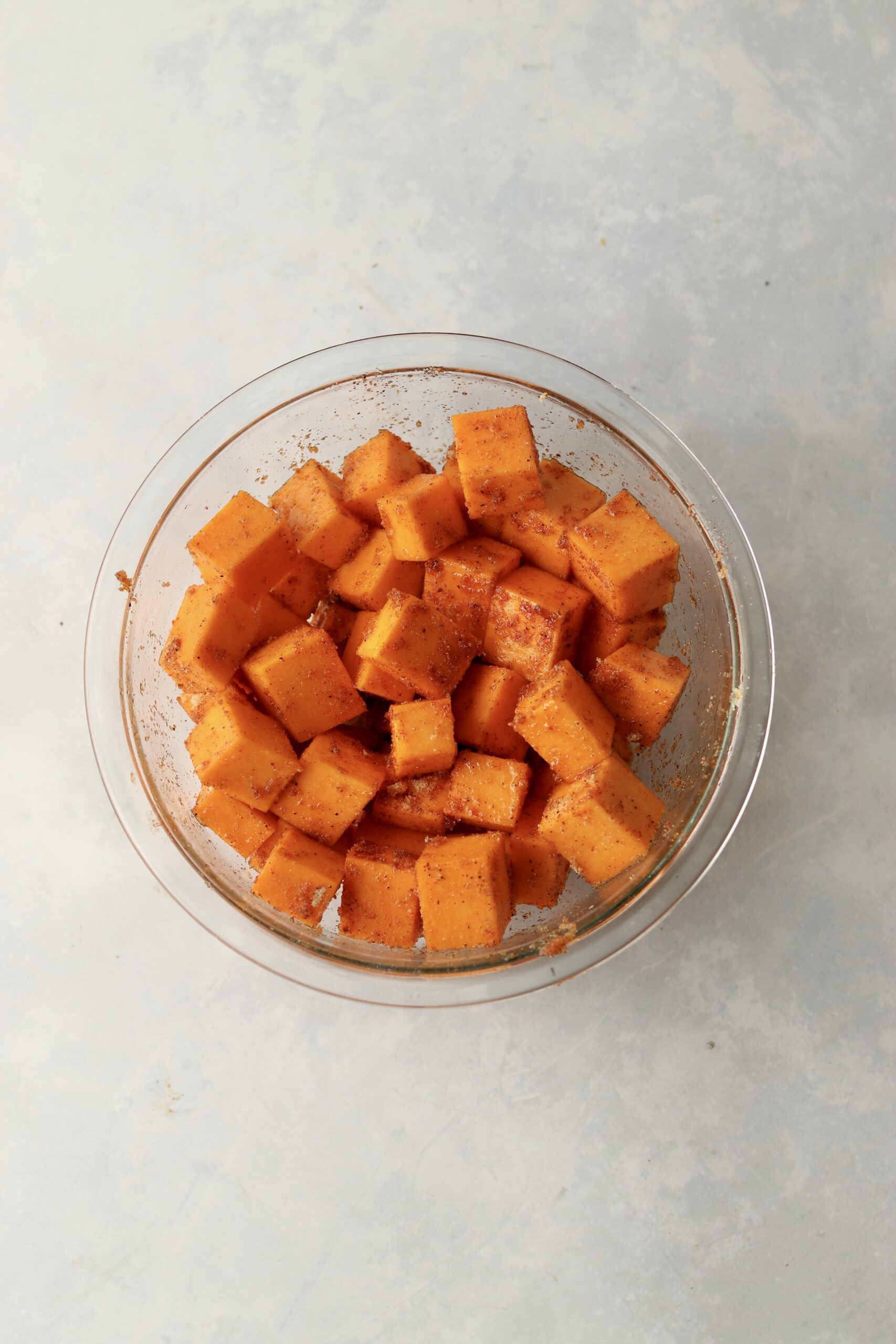 diced butternut squash tossed in oil and spices.