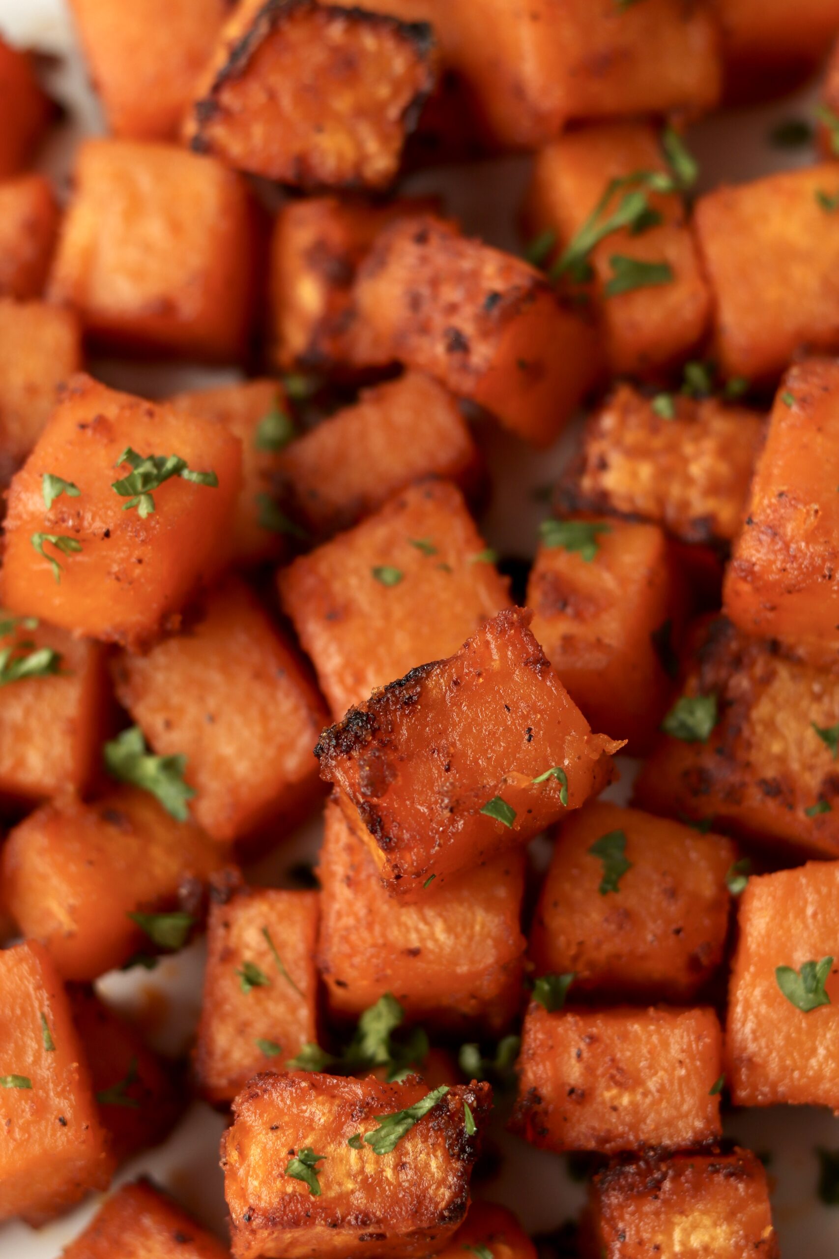 close up of tender and browned butternut squash cubes