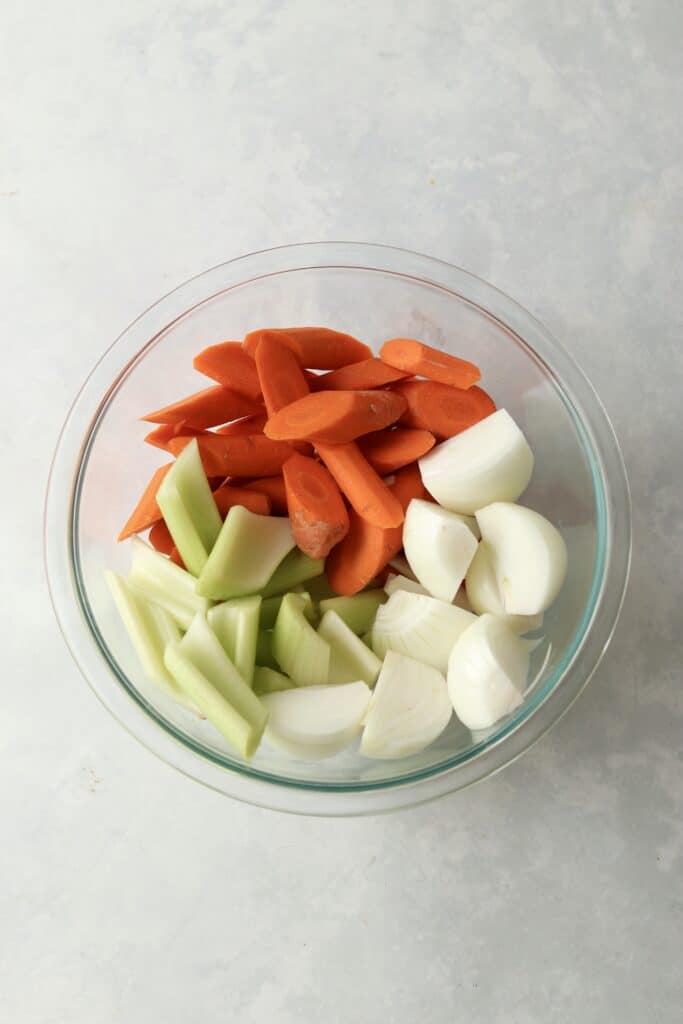 chopped carrots, celery, and onions in glass bowl