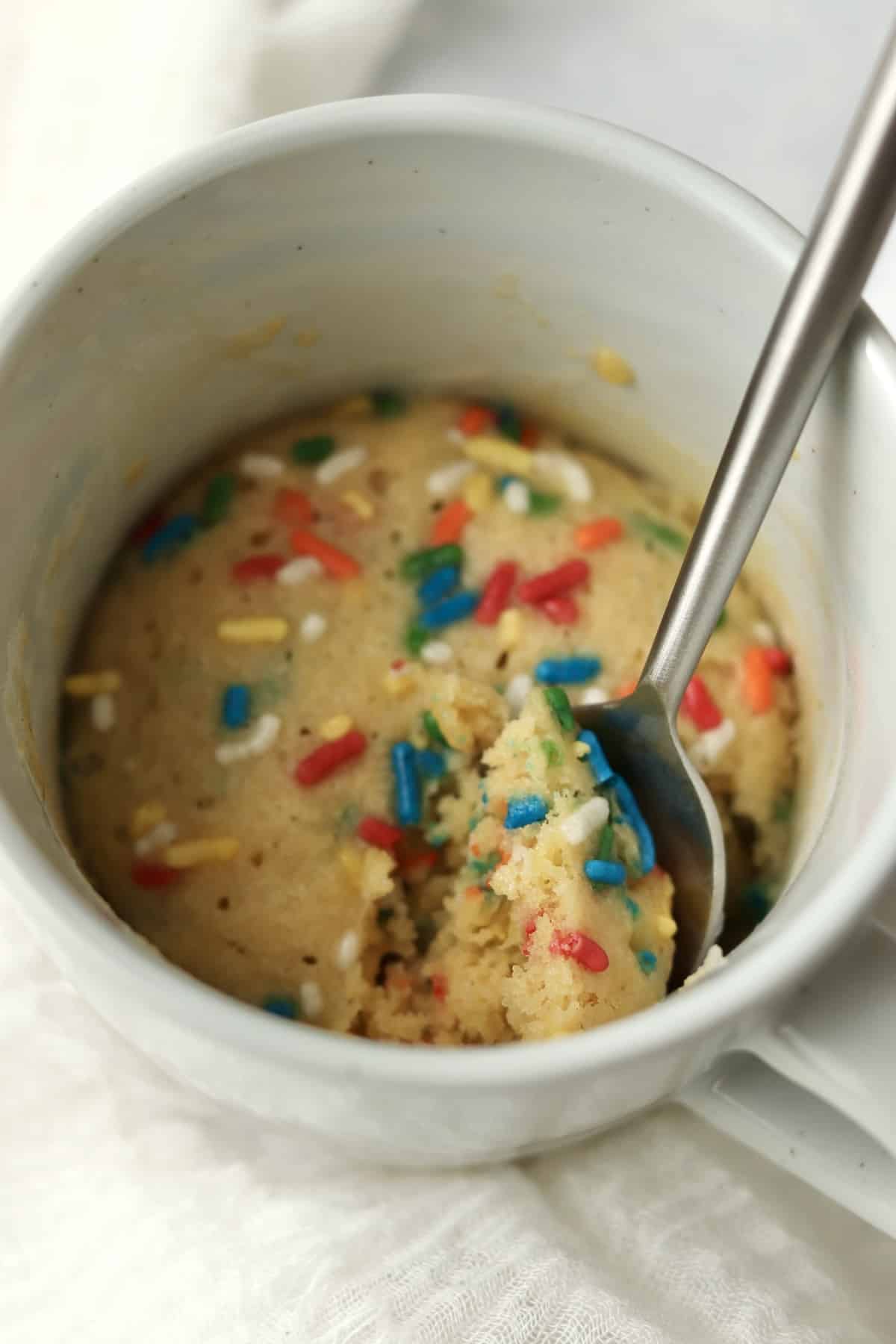 spoon digging into a mug sugar cookie