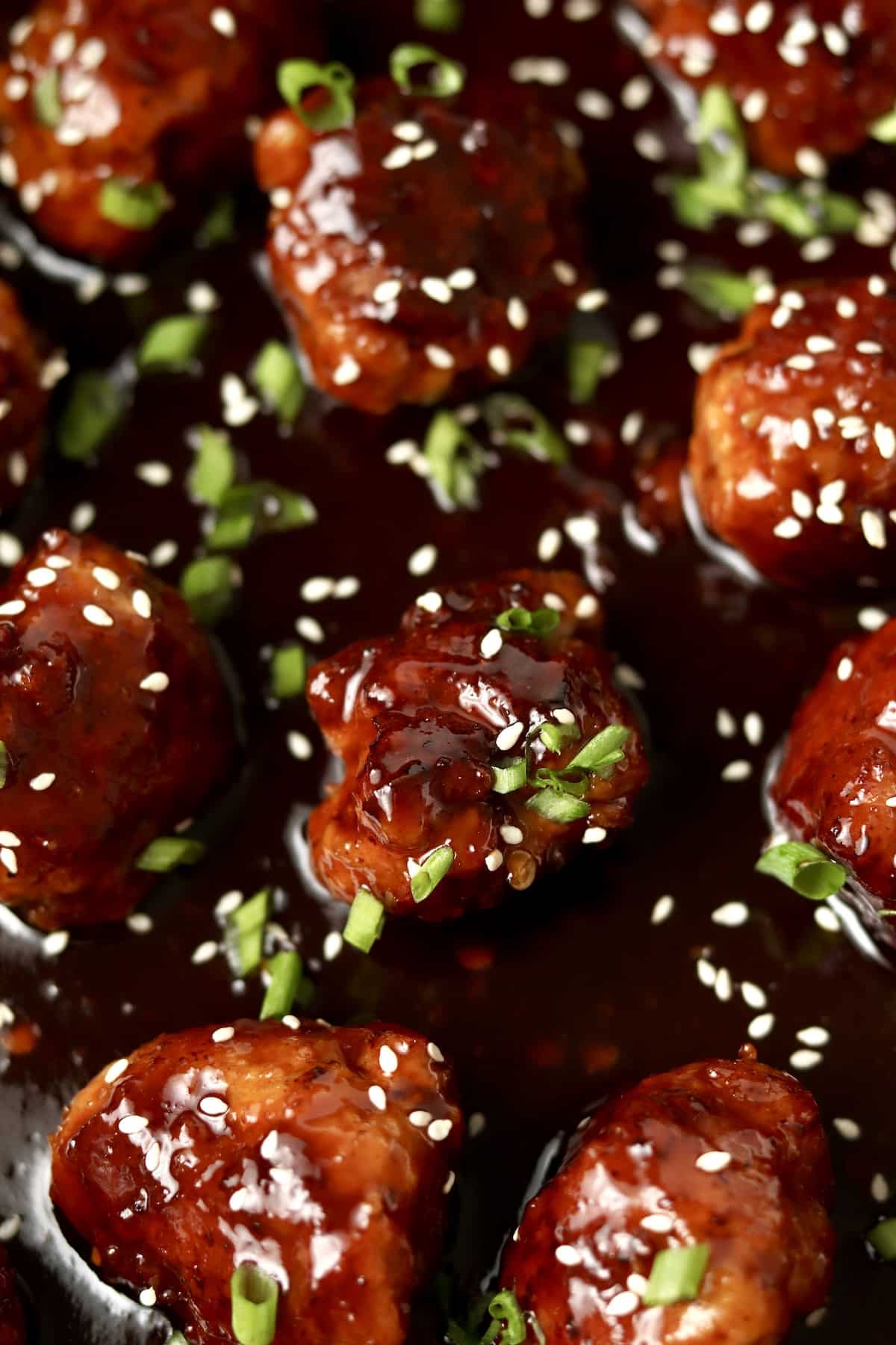 close up of asian pork meatballs sprinkled with sesame seeds