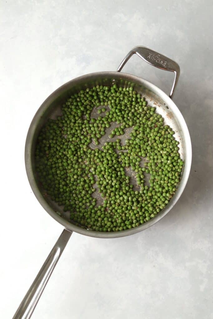 sautéed peas and garlic in large pan