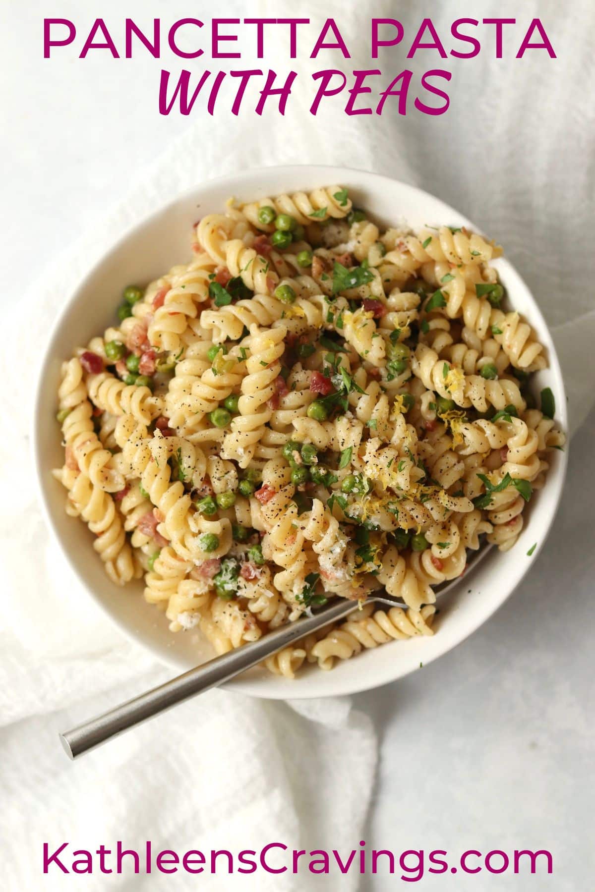 bowl of pancetta pasta with peas on a white background
