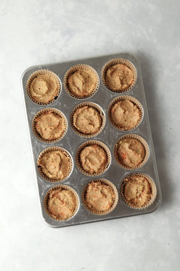 carrot cake batter in a muffin pan