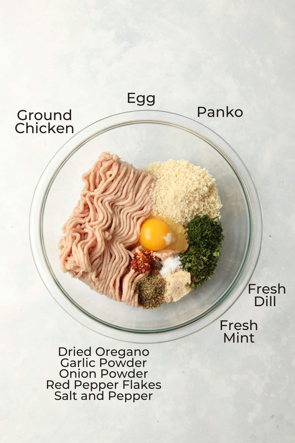 ground chicken, egg, Panko, spices, and herbs in a mixing bowl