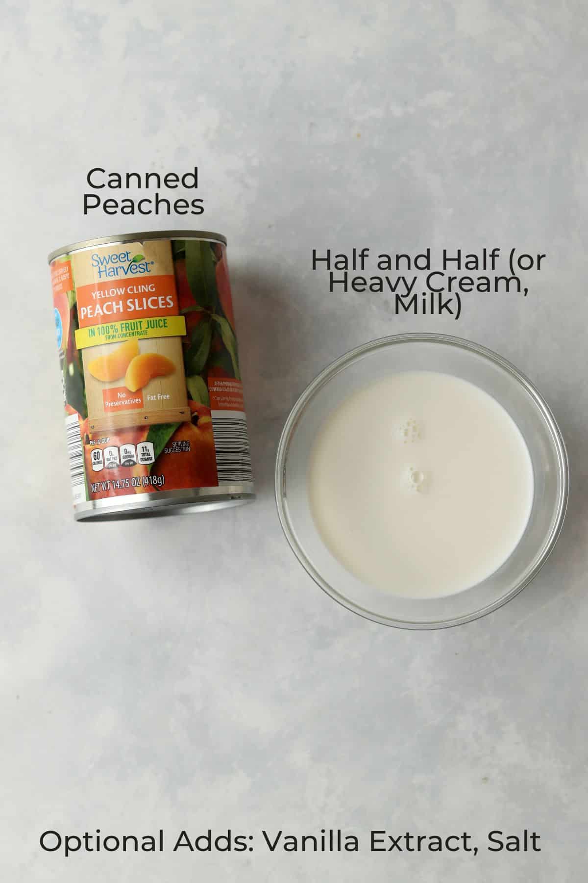 canned peaches and half and half in a small bowl arranged against a marble background.
