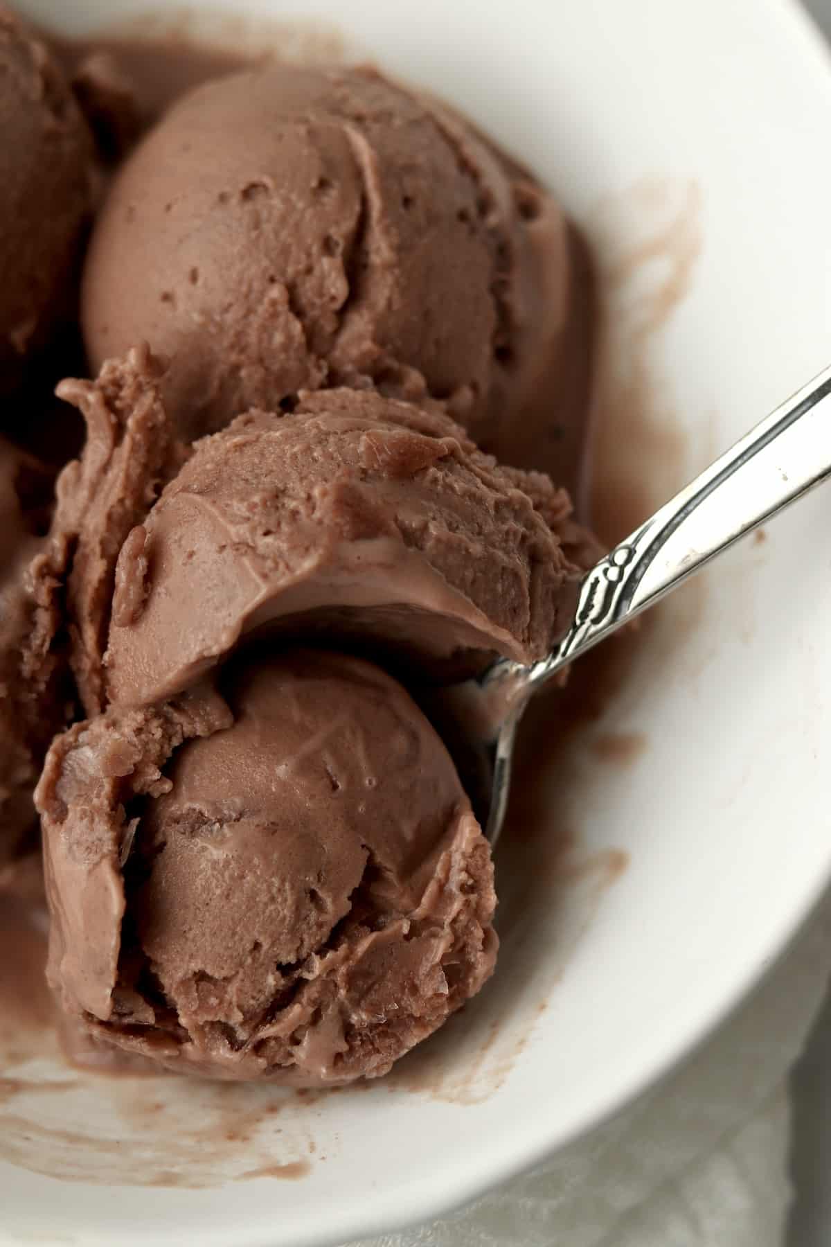 spoon digging into chocolate protein ice cream made in Ninja Creami