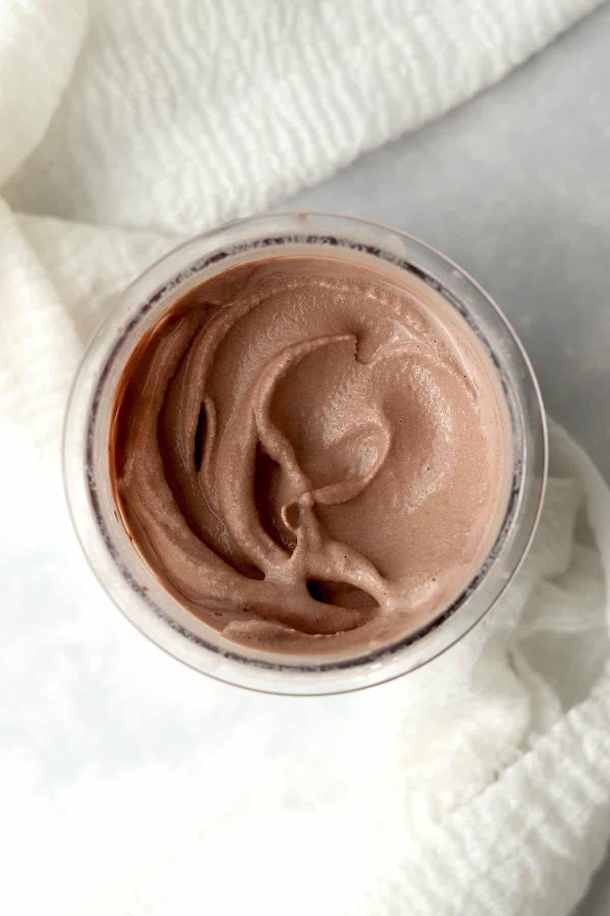 Copycat Wendys Chocolate Frosty in pint container with swirl on top.