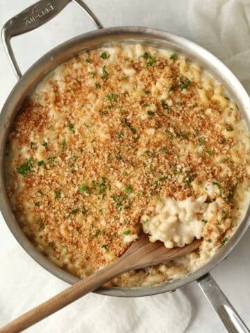 White cheddar Mac and cheese in pan with breadcrumbs.
