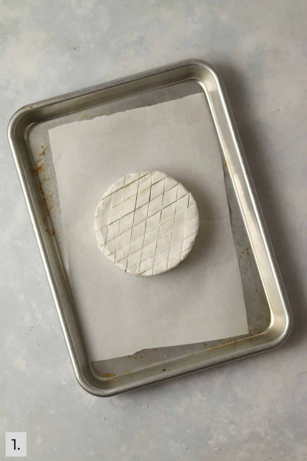 Brie round on baking sheet.