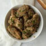 Air Fryer Garlic Parmesan Wings tossed in a sauce with fresh Parmesan Cheese.