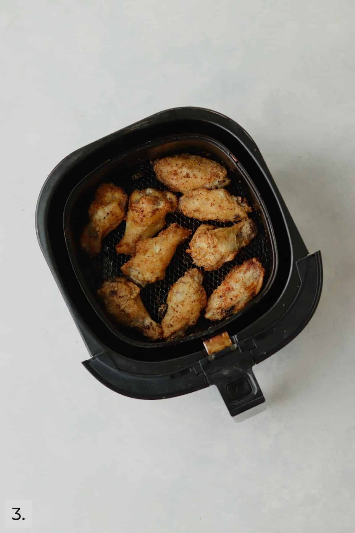 Cooked chicken wings in air fryer.