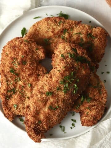 Air fryer parmesan crusted chicken on a plate.
