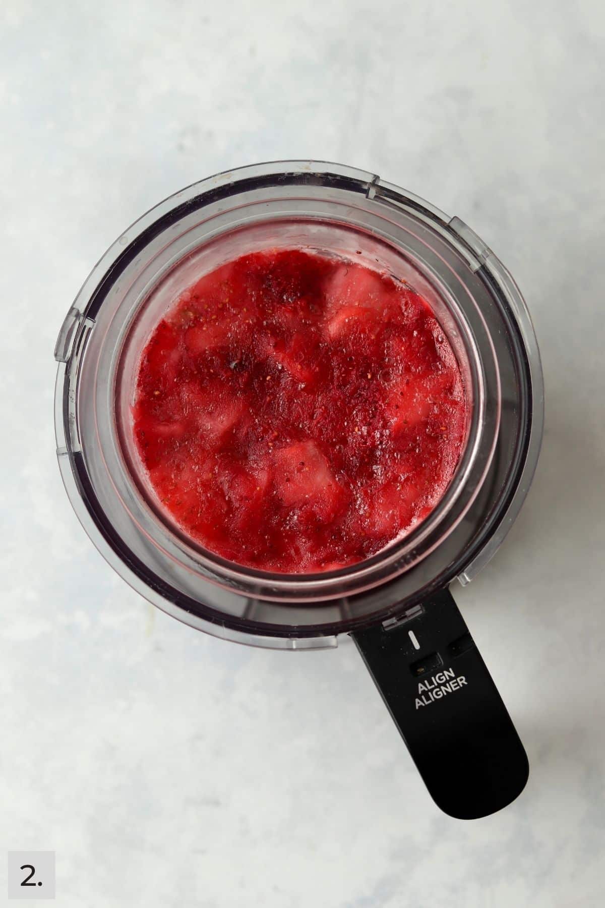 Frozen mixed berry sorbet in Ninja Creami before blending.